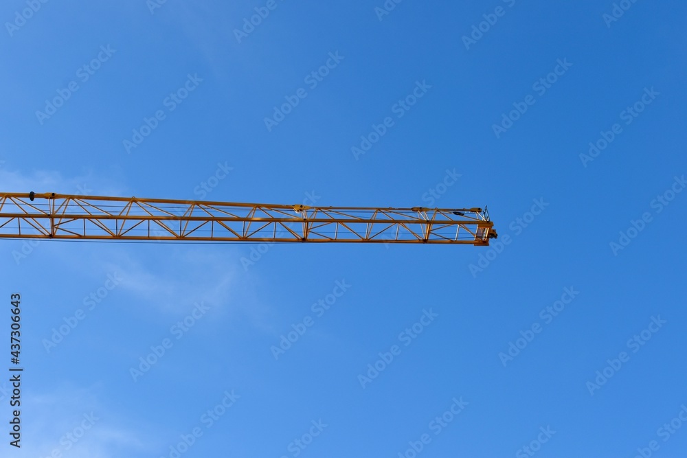 Yellow tower crane and blue sky
