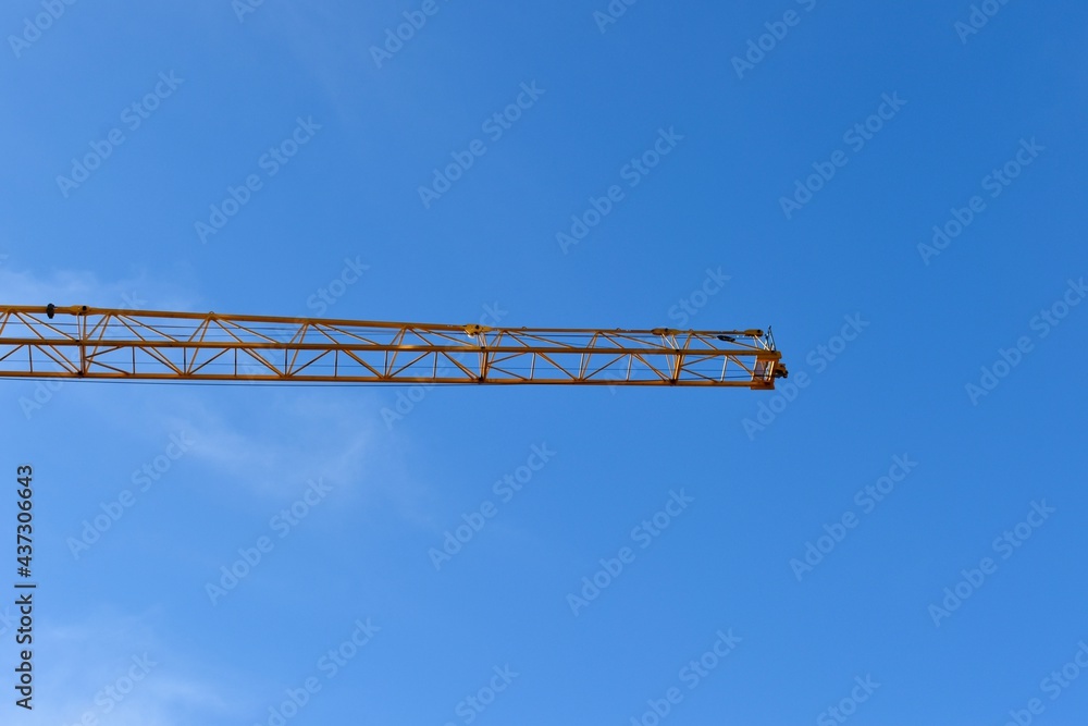 Yellow tower crane and blue sky Yellow tower crane and blue sky