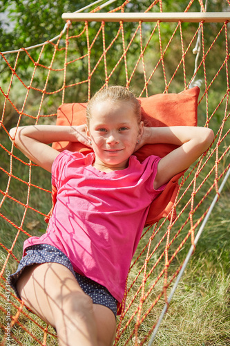 Summer vacation - lovely girl in wicker hammock