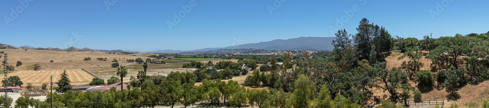Santa Inez, CA, USA - April 3, 2009: San Lorenzo Seminary. Panorama shot over valley west shows agriculture, mountains and dark foliage trees sprinkled around.