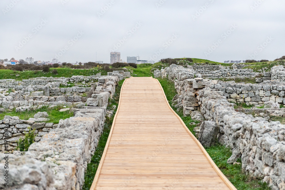 Wooden flooring in archaeological sites. The ruins of a thousand-year-old city and the path along them.