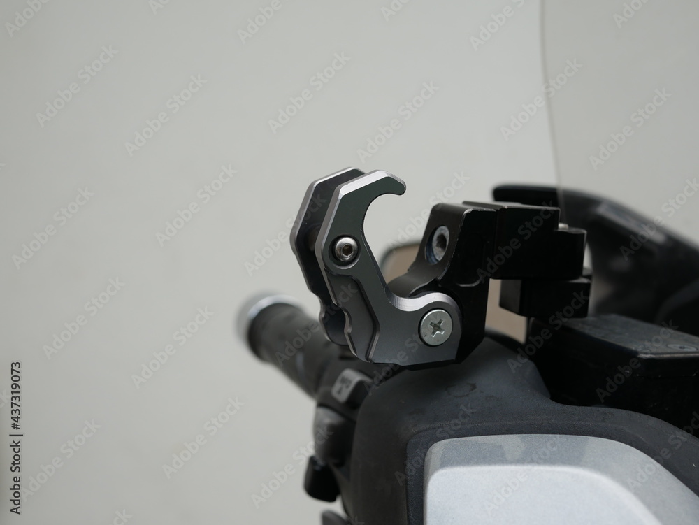 aluminum hook on motorcycle for hanging material or helmet.