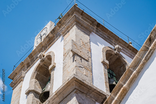 Perspective of church bell tower with stone clock and sundial, Pedrogão Pequeno PORTUGAL photo