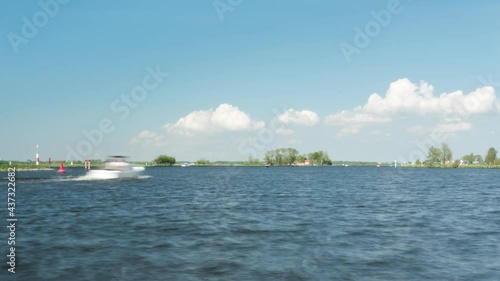 Time lapse of sailing boats on lake Kagerplassen in Holland on summer day photo