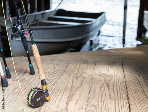 Fishing rods and reels in the boat house on the river