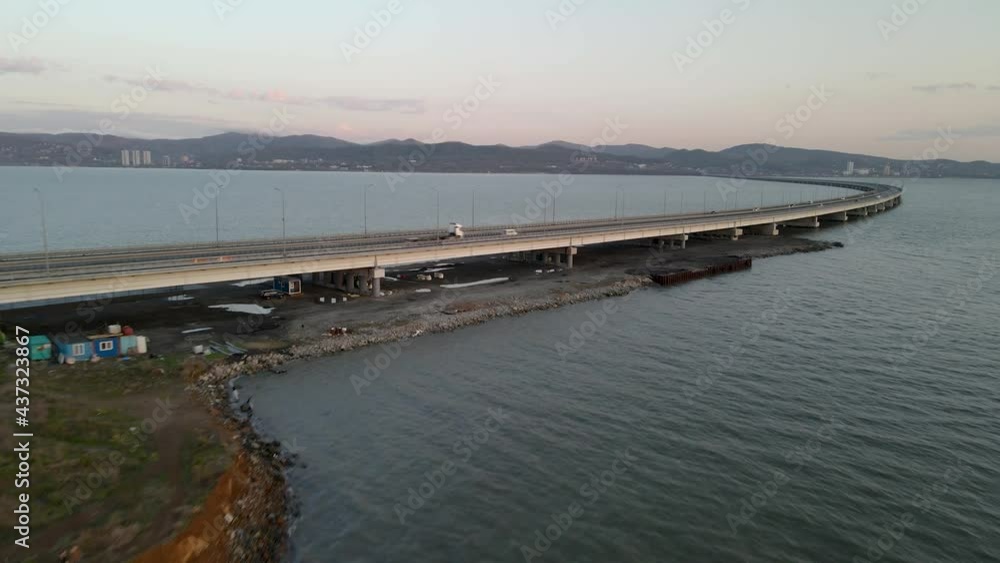 Aerial forward Vladivostok costal cityscaspe low-water bridge across blue sea. Aerial forward Vladivostok costal cityscaspe low-water bridge across blue sea.