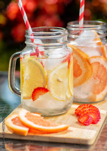 two cups of lemonade with grapefruit and strawberry  