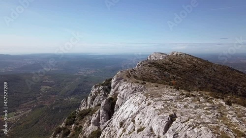 Flying close to a mountainous rocky outcrop high above St. Victoire, Aix en Provence, France, aerial photo
