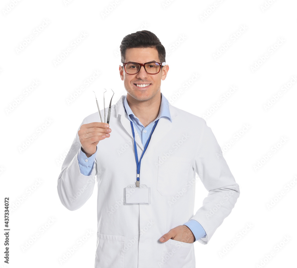 Male dentist with tools on white background