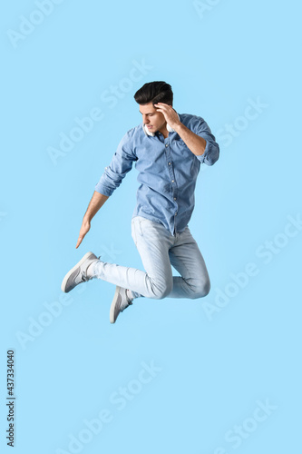 Jumping handsome man with h...