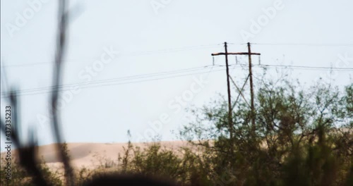 Heat wave distorting power lines and sand dunes in Yuma Desert, Arizona America