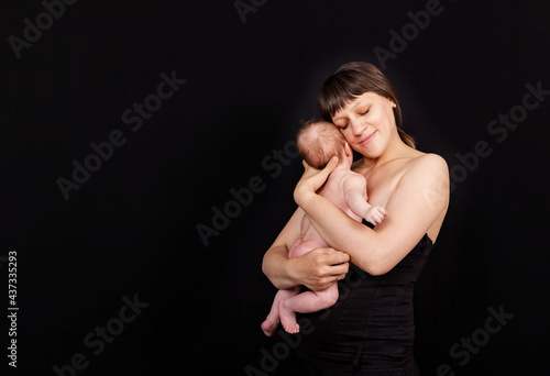 Loving mom carying of her newborn baby. Happy mother with her baby boy. Young mother kissing adorable newborn baby. Beautiful mother holding her cute son.Mother and her newborn baby together.