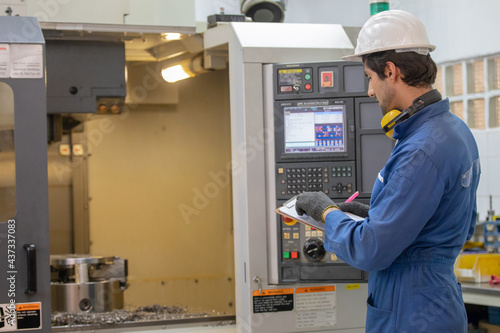 Workers inspecting workpieces from CNC machines. The worker measures the part installed on the machine with a cnc measuring tool.