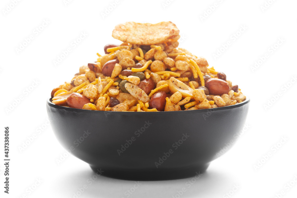 Close-Up of Hot spicy Nav Ratan snacks in a black Ceramic bowl, made with red chili, peanuts. Indian spicy snacks (Namkeen), Close-Up of Hot spicy Nav Ratan snacks in a black Ceramic bowl, made with red chili, peanuts. Indian spicy snacks (Namkeen),