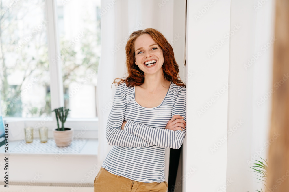 Charismatic happy young woman laughing merrily at camera