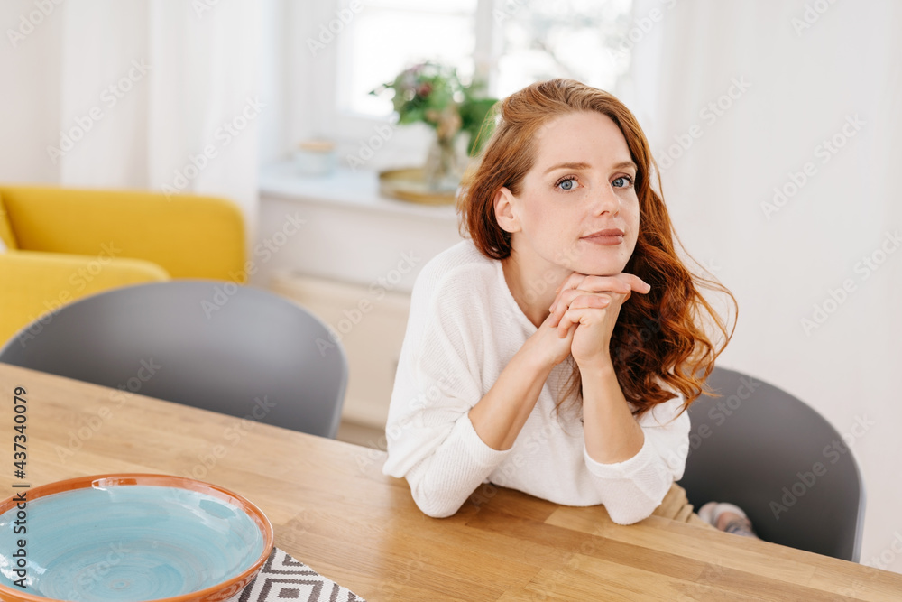 Young woman glancing sideways at the camera with wide eyes Young woman glancing sideways at the camera with wide eyes