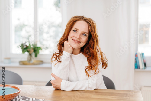 Cute young redhead woman with a sweet friendly smile
