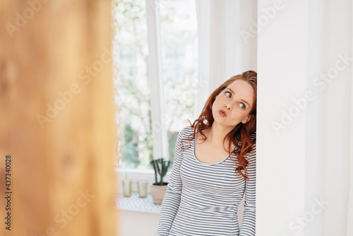 Young woman standing thinking with look of anticipation