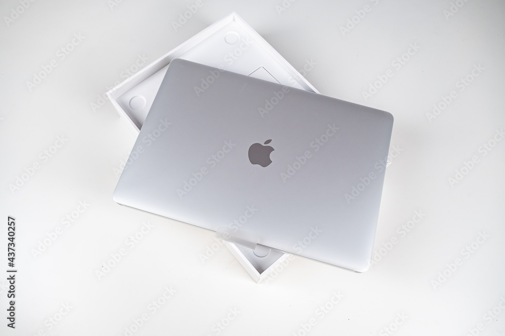 Unboxing a silver macbook air on a white table. Apple laptop Stock Photo |  Adobe Stock