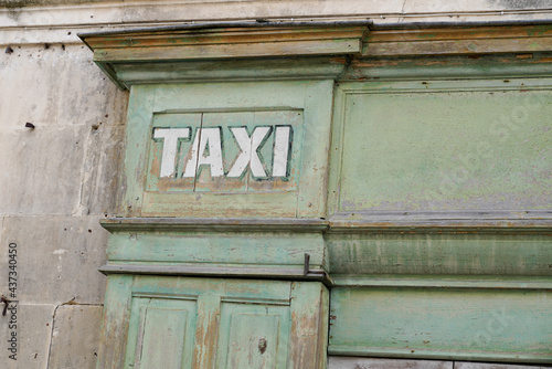 old vintage taxi sign on wooden office agency of cab driver