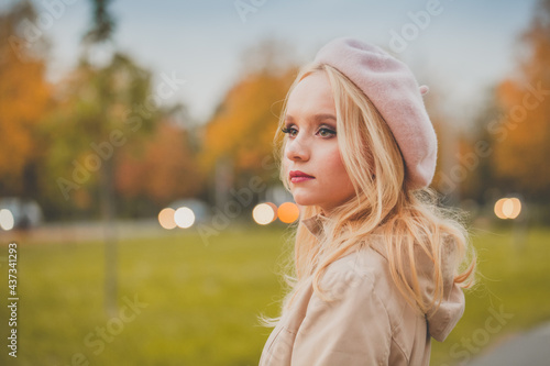 Autumn mood. Young pensive woman against fall nature outdoor