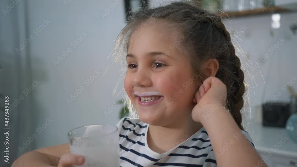 Little girl drinks milk for breakfast. Organic drink. Girl with glass of milk. Organic healthy product. Child with a glass of milk. Child drinks milk for breakfast. Organic healthy products concept. Little girl drinks milk for breakfast. Organic drink. Girl with glass of milk. Organic healthy product. Child with a glass of milk. Child drinks milk for breakfast. Organic healthy products concept.