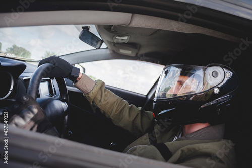 Rally driver concept. Man in the helmet drives a car.