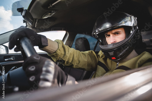 Rally driver concept. Man in the helmet drives a car. © Dmitriy