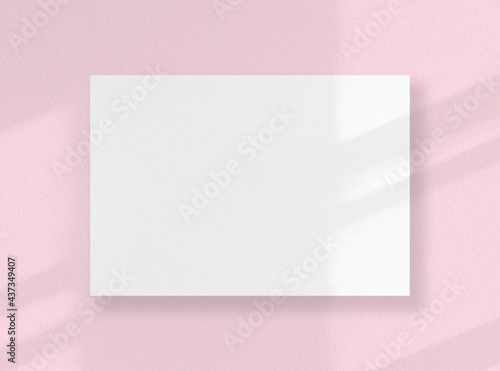 Blank square card, white sheet as mockup with sunny shadows on pink surface.
