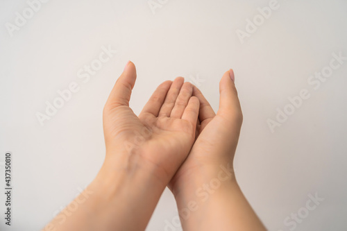 two open empty female hands with palms up, holding something, isolated on white background