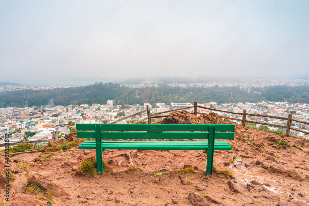 Bench on a hill for viewing panoramic views of the city of San Francisco in a residential area