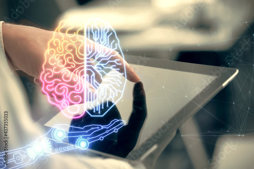 Double exposure of man's hand holding and using a digital device and brain hologram drawing. Data concept.