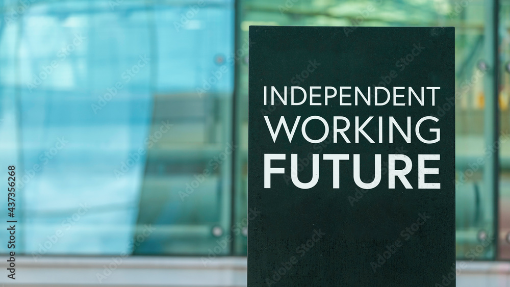Obraz premium Independent Working Future on a sign outside a modern glass office building 