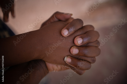 AFRICAN MAN AND WOMAN HOLDING HANDS, 