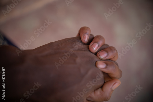 AFRICAN MAN AND WOMAN HOLDING HANDS, 