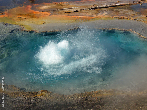  pretty blue hot spring and orange microbial mat along firehole lake drive in yellowstone national park, wyoming 