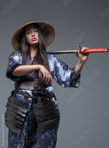 Woman samurai with bamboo hat and sword