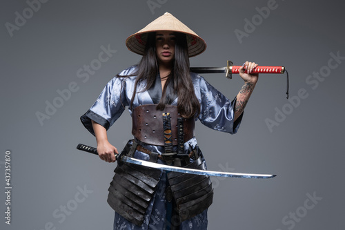 Woman samurai dressed in armored kimono with katana