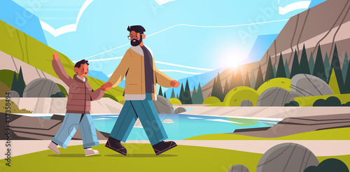 young father walking outdoor with son parenting fatherhood concept dad spending time with his kid