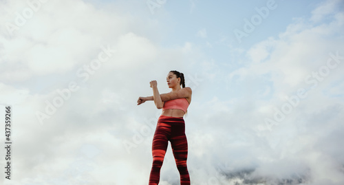 Female athlete doing stretching workout outdoors