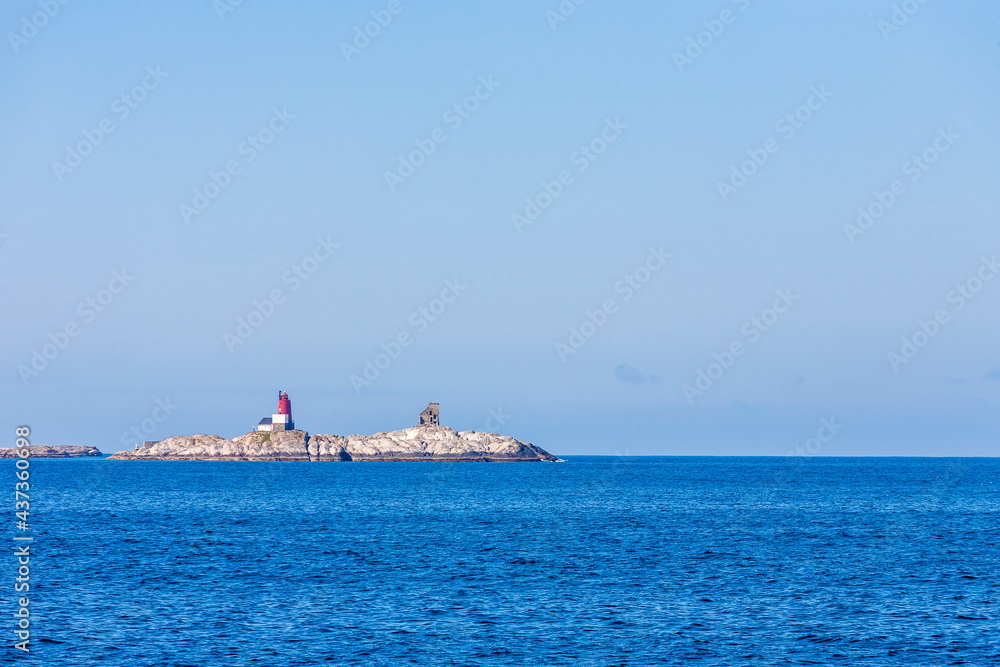 Lighthouse on a small island in the sea