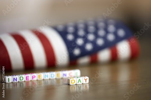 American flag on a wooden surface with the inscription Independence Day.July 4, USA