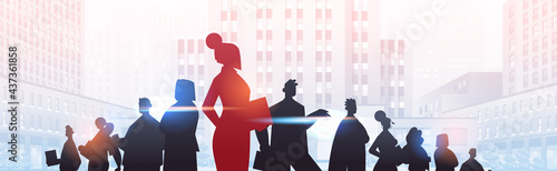 red businesswoman leader silhouette standing in front of businesspeople group leadership business competition