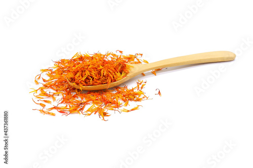 Obraz na plátně A pile of Dried Safflower petals herb Tea and a wooden spoon