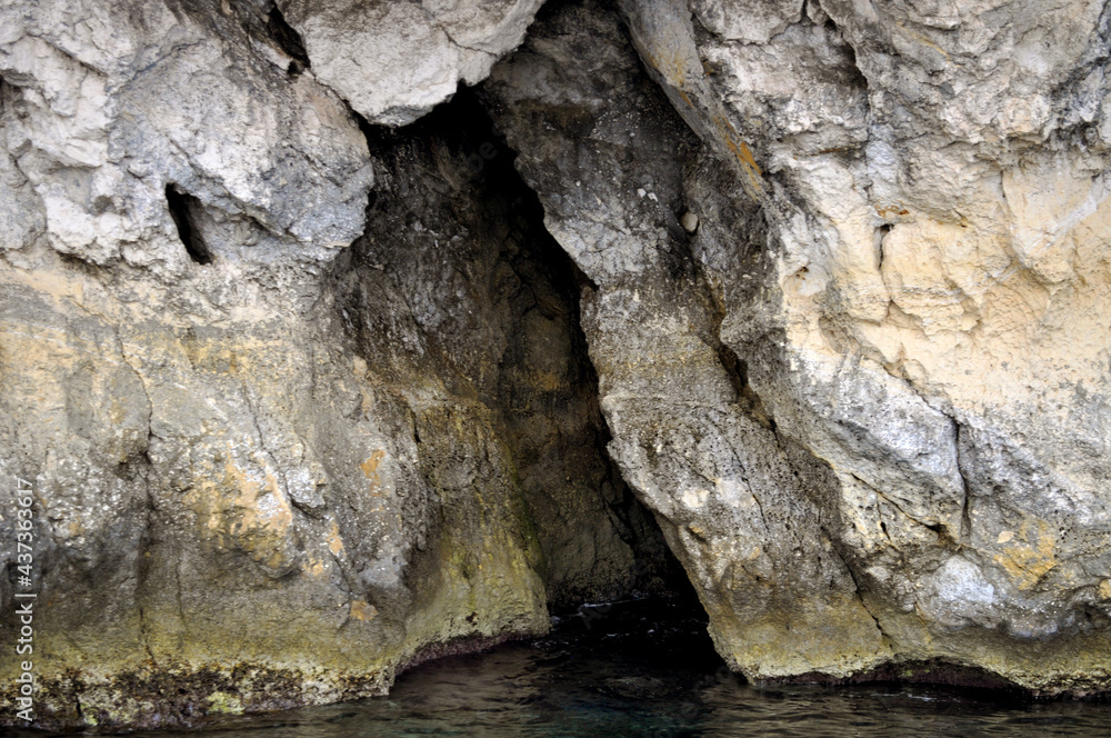 A picture of a sea cave taken by a boat along the rocky coast of  Malta ,Europa.