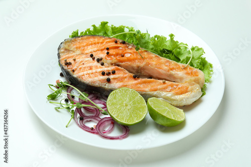 Concept of tasty eating with grilled salmon on white background