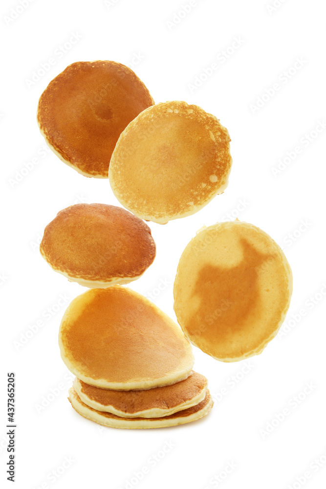 Tasty falling pancakes isolated on white background