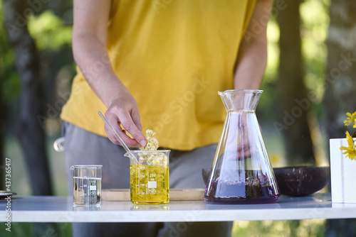 Woman making natural cosmetics on a laboratory table in nature