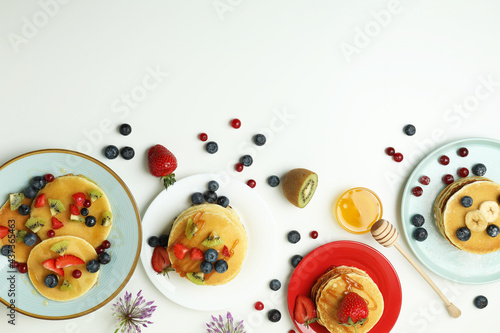 Fototapeta Naklejka Na Ścianę i Meble -  Concept of delicious dessert with pancakes on white background