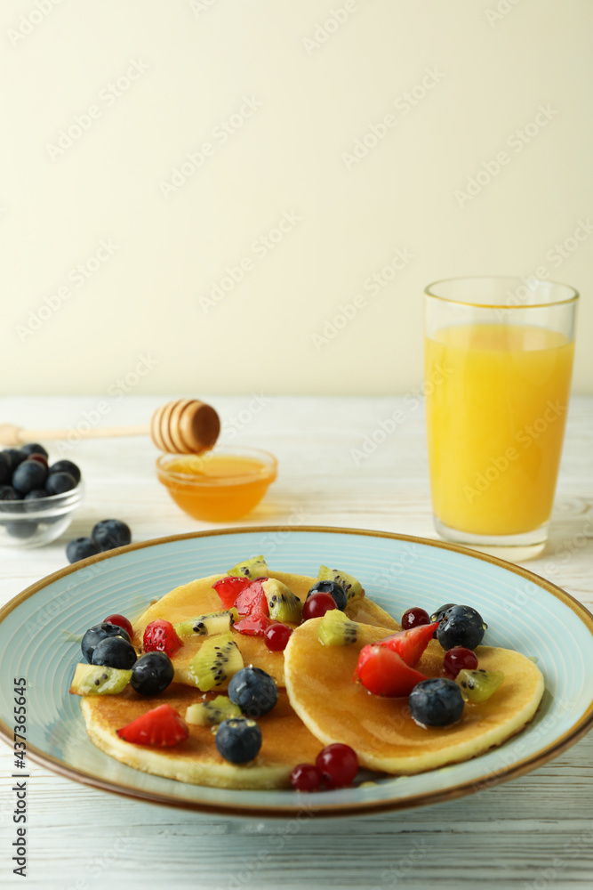 Concept of delicious dessert with pancakes on white wooden table Concept of delicious dessert with pancakes on white wooden table